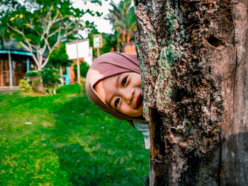 Low angle view of woman standing on tree