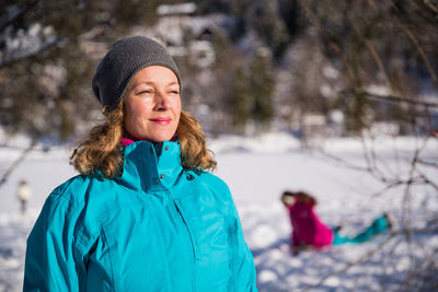 Portrait of a smiling young woman in snow