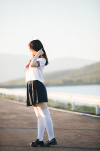 Full length woman in uniform standing outdoors