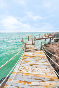 Rock and wood bridge by the sea