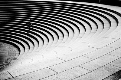 High angle view of person walking on spiral staircase