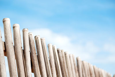 Low angle view of fence against sky