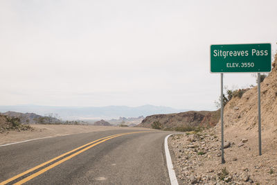 Information sign on road against clear sky at route 66