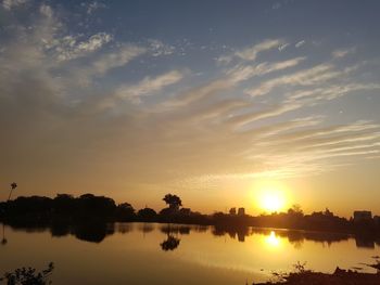 Scenic view of lake against sky during sunset