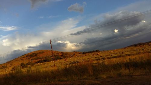 Scenic view of mountains against cloudy sky