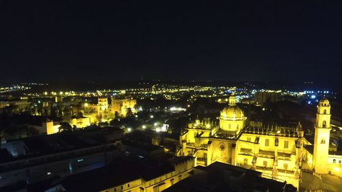 High angle view of illuminated buildings in city at night