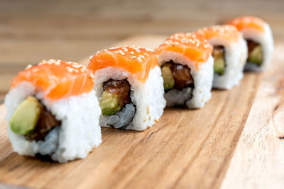 Sushi rolls on wooden table