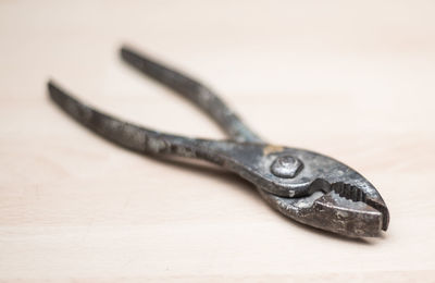 Close-up of pliers on table