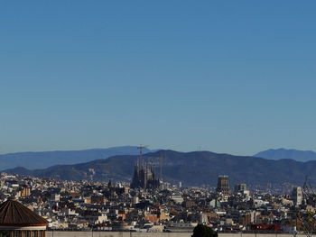Cityscape against clear blue sky