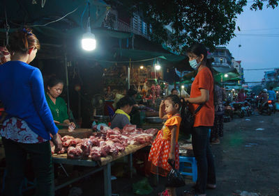 Group of people at market stall