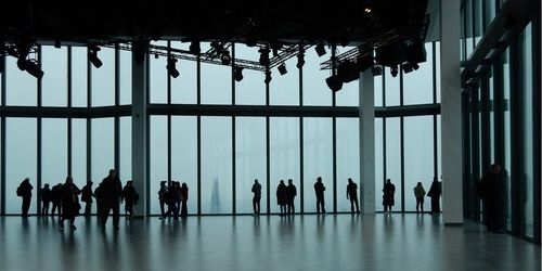 Silhouette people walking on street