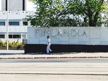 Full length of man walking on street in city