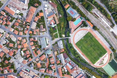 Aerial top view of the city and sports recreation fields ground, city stadium