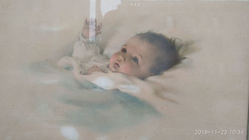 Portrait of boy lying down in bathroom