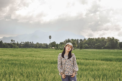 Young woman standing in field