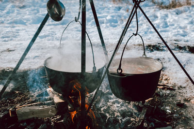 The food is cooked in two pots over a fire