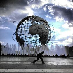 Silhouette of people against cloudy sky