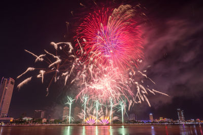 Low angle view of firework display at night