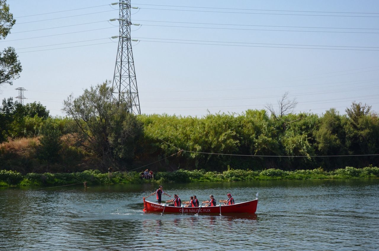 clear sky, water, tree, lake, waterfront, nautical vessel, tranquility, transportation, nature, river, copy space, boat, reflection, tranquil scene, day, mode of transport, growth, outdoors, beauty in nature, scenics