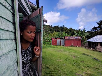 Young woman standing by door