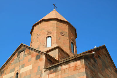 Low angle view of building against clear blue sky