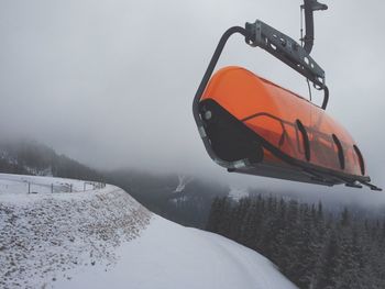 Empty ski lift over snow covered landscape