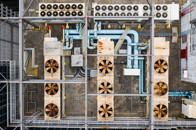 Directly above shot of pipe hanging on metal grate