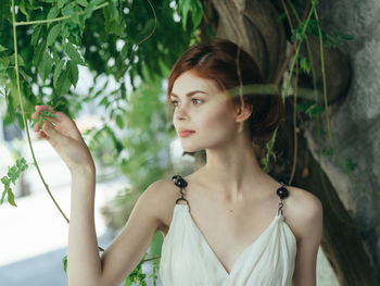 Portrait of young woman looking away