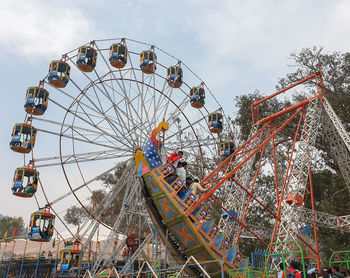 Low angle view of ferris wheel against sky