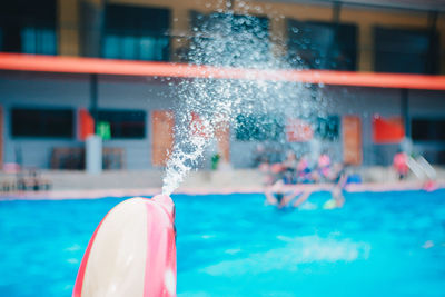 Reflection of people in swimming pool