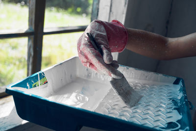 Close-up of person working in tray