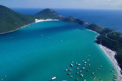High angle view of sea shore against blue sky