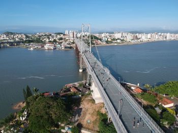 High angle view of cityscape by sea against sky