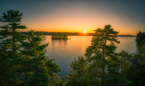 Scenic view of lake against sky during sunset