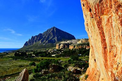 Scenic view of mountain against blue sky