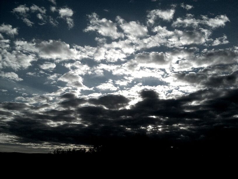 sky, silhouette, cloud - sky, tranquility, tranquil scene, beauty in nature, scenics, cloudy, nature, low angle view, cloud, cloudscape, sunset, weather, idyllic, overcast, dramatic sky, tree, dark, landscape