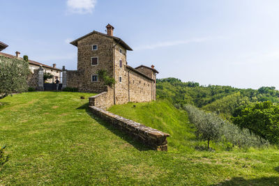 Old building on field against sky