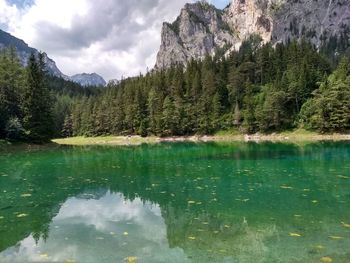 Scenic view of lake by mountains against sky