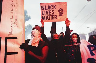 Low section of people standing on sign board