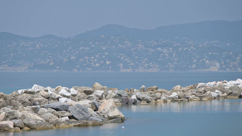 Scenic view of sea and mountains against sky