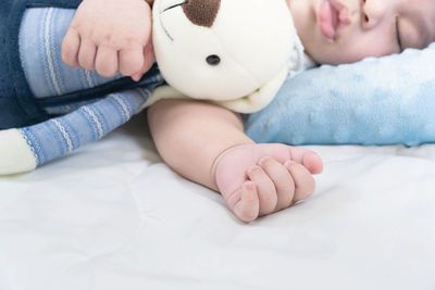 Midsection of baby boy lying on bed