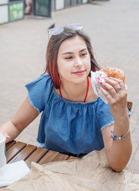 Portrait of smiling young woman holding ice cream