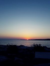 Scenic view of sea against clear sky during sunset