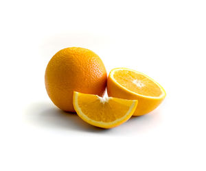 Close-up of orange fruit against white background