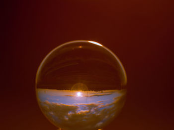 Close-up of glass against illuminated background