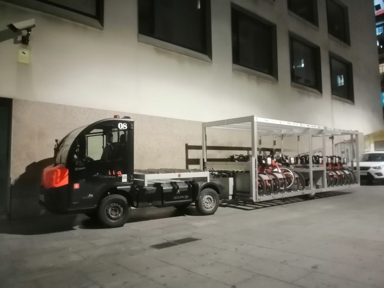 CARS PARKED ON ROAD BY BUILDING