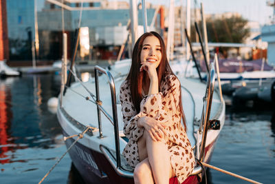 Young woman in boat on shore