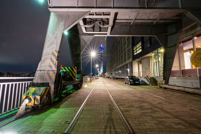 Illuminated railroad station platform at night