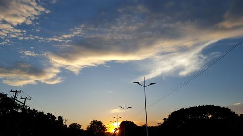 Low angle view of silhouette trees against sky at sunset