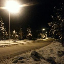 View of illuminated street lights at night